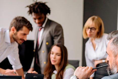 Five coworkers are talking about collaboration at work